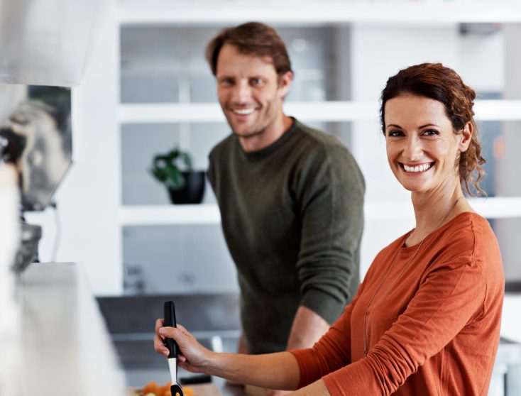 Portrait of a smiling mature couple cooking together in their kitchen
